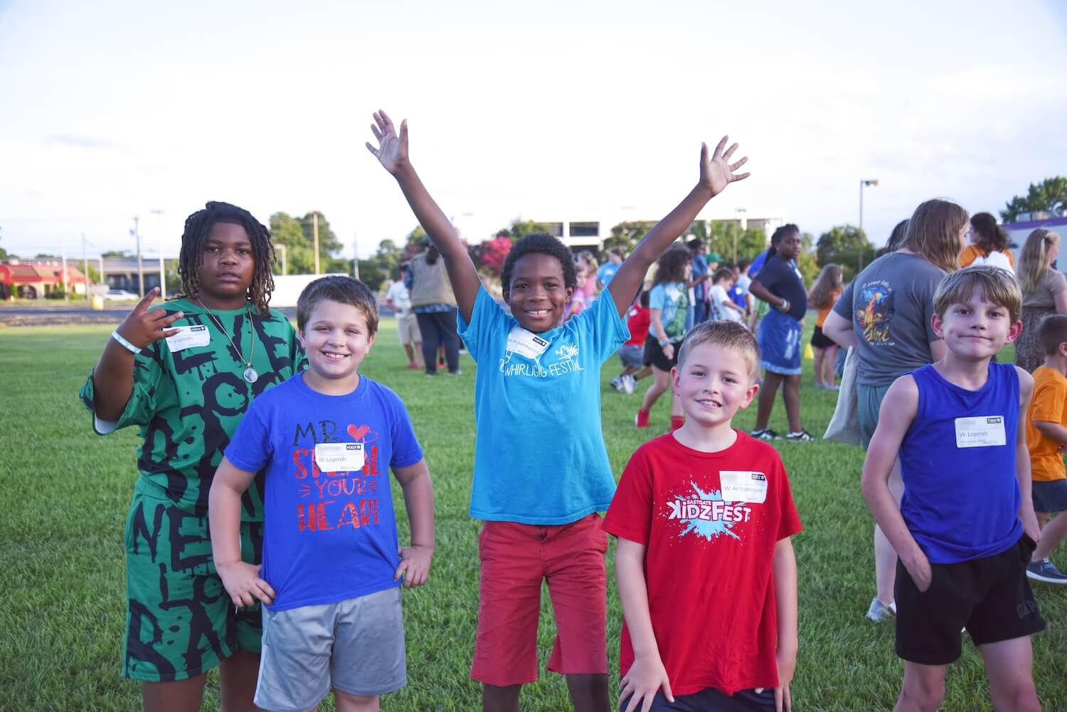 Kids cheering with arms raised at KidzFest